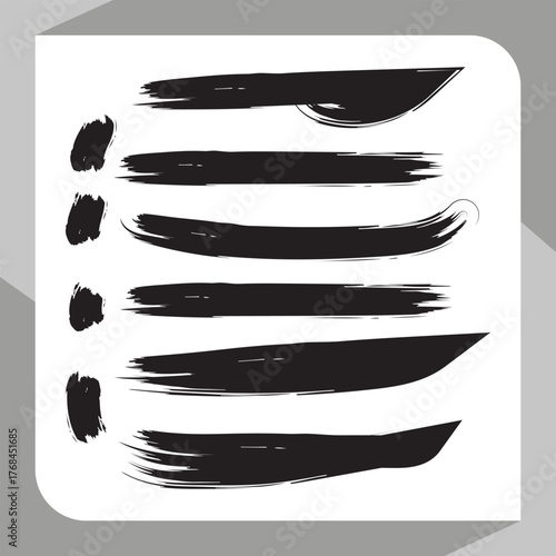 Set of black and white paint brush strokes and sharp stainless steel knives on a white surface