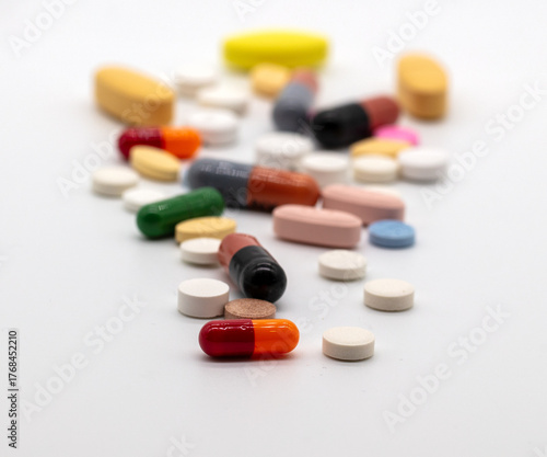 Medication, a variety of tablets pills and capsules on a white background