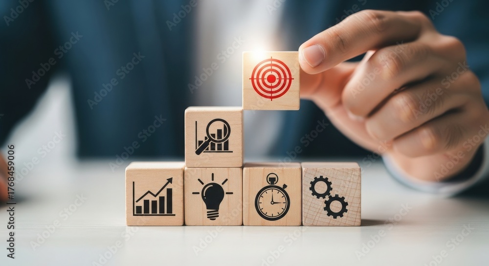 Naklejka premium Hand placing target block on wooden blocks representing business goals and strategy