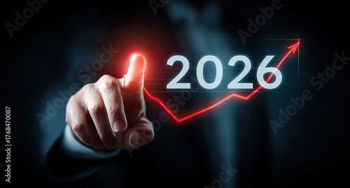 Businessman touches year 2026 with growing red arrow chart