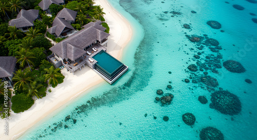 Fototapeta Naklejka Na Ścianę i Meble -  Luxury tropical resort villas with private pools nestled on idyllic white sand beach and turquoise ocean