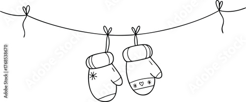 Two mittens hanging on a string winter warmth and festive cheer.