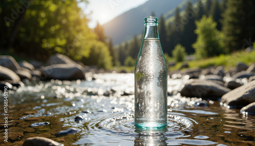 Glass bottle of alkaline water in clear stream surrounded by nature  