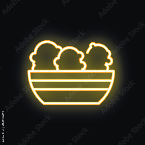 Neon sign of a salad bowl glowing yellow against a dark background, perfect for a healthy restaurant or cafe