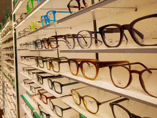 Rows of glasses on display on the shelves of an opticians, England, UK