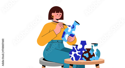 Artisan Crafting Ceramic Vases With Brush and Paints on a Small Round Table