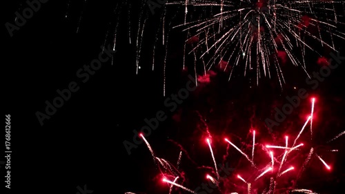 Bright colorful festive glowing fireworks on night sky.  New Year, Christmas, festival, party and holiday celebration concept