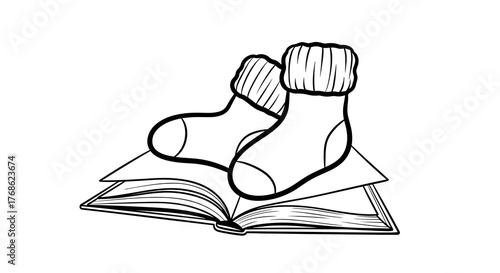 Winter socks draped over an open book in a cozy setting  
