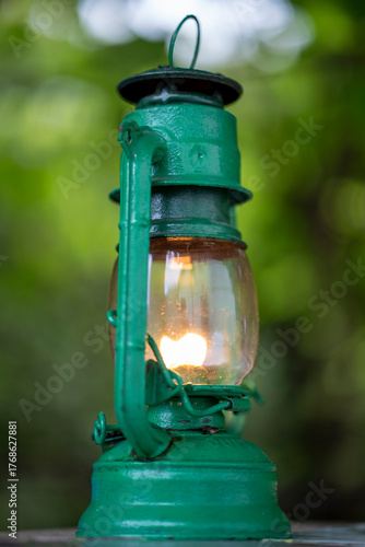 Antique green lantern glowing with soft warm light