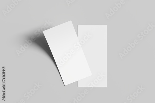 Minimalist composition with two blank white sheets of paper placed side by side on a light gray surface. Perfect for mockups, print design presentations, or background templates.