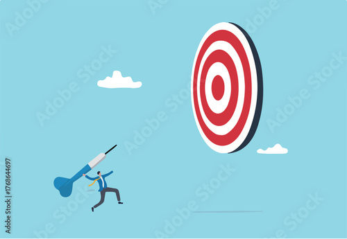 Aiming for big goal, challenge to achieve target, success or accuracy, ambition or determination to reach business target concept, businessman throwing huge dart, aiming to hit dartboard bullseye.