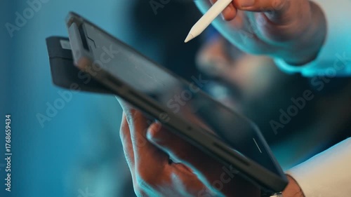 Indian male customer service agent or call center wearing a headset and glasses discussing with client at the office. Professional remote work, technical support. Telecommuting, telemarketing