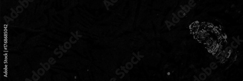 This background features a dark surface with a gritty effect, displaying textures that evoke a sense of age and wear. Ideal for design projects needing a vintage touch.