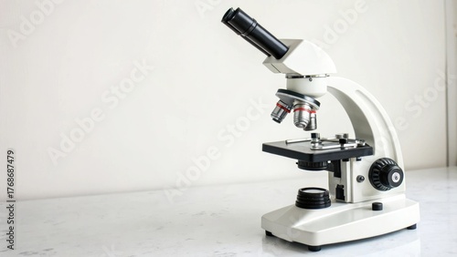 Modern white microscope on a white surface for scientific research and education