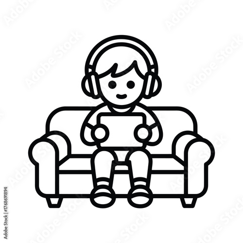 Child wearing headphones plays on a tablet while sitting on a couch