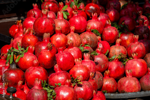 Fresh Pomegranates Stacked at a Market Stall