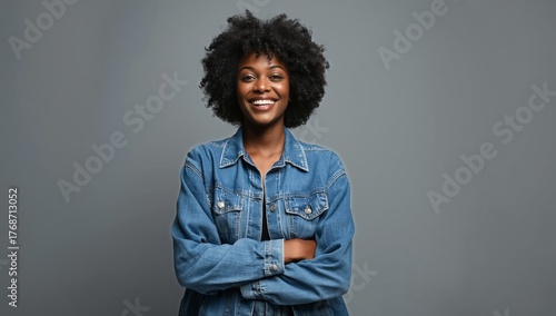 Confident Young Woman Smiling With Crossed Arms Against a Gray Background in ...