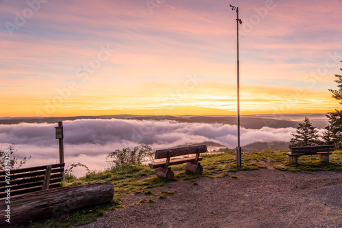 Sunrise casts a warm glow over the Rhine River near Bad Salzig in Germany with misty clouds below