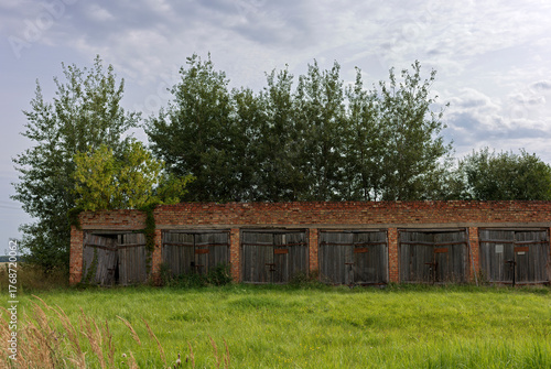 Red brick garages with wooden doors