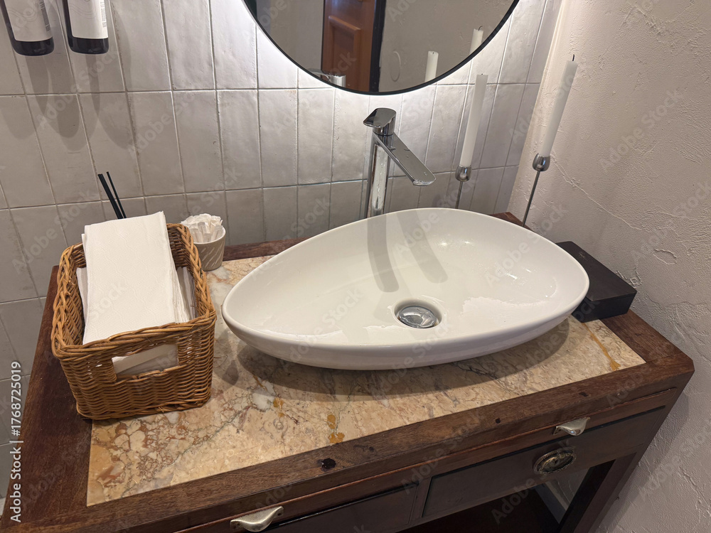 Fototapeta premium Stylish sink on wooden vanity in restroom interior. Cleanliness, design harmony, and comfort in modern hospitality environment.