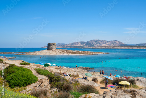 Fototapeta Naklejka Na Ścianę i Meble -  La Pelosa paradise beach with historic tower and turquoise water in Sardinia, Italy