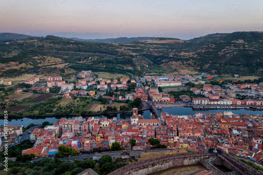 Fototapeta premium Bosa historic city aerial drone view of colorful buildings at sunset in Sardinia, Italy