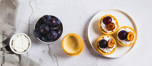 Mini baking with ricotta and berries on a plate on the table top view web banner