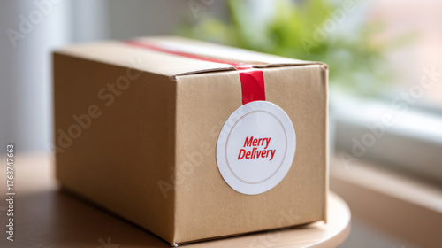 Close-up view of a cardboard shipping box with festive sticker and red tape in soft daylight at home