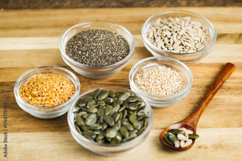 Naklejka premium Assorted Bowls with Mixed Seeds (flaxseed, chia, sesame, pumpkin, and sunflower seeds)