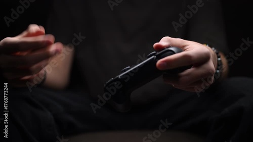 Close-up of tired hands holding a game controller, symbolizing hand strain and the health impact of long gaming sessions. Dark mood lighting highlights fatigue and a sedentary lifestyle.