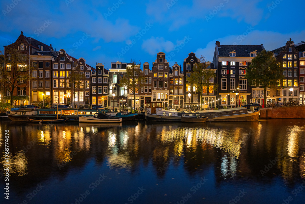 Fototapeta premium Reflections on an Amsterdam canal at night