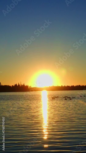 Golden Sunset Over Calm Lake as the Sun Slowly Sets
