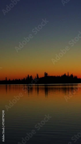 Golden Sunset Over Calm Lake as the Sun Slowly Sets
