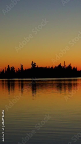 Golden Sunset Over Calm Lake as the Sun Slowly Sets
