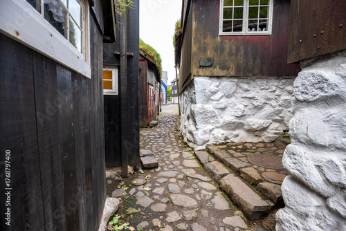 Historic cobblestone alley with turf-roofed wooden houses