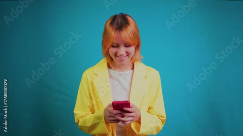 Young smiling woman using smartphone for texting