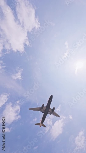Airplane flying overhead coming in to land in vertical