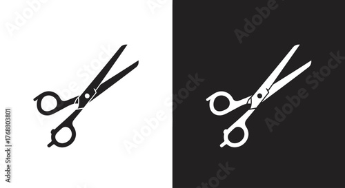 A black and white graphic illustration of scissors, presented on contrasting backgrounds.