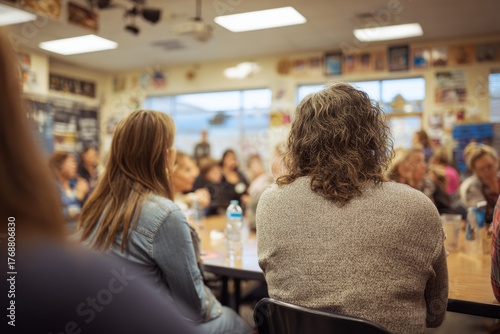 parent - teacher conference. Parents and teachers in a PTA meeting, view rom the back, natural candid moment. Public hall gathering, social event. People daily life. Education and politics.