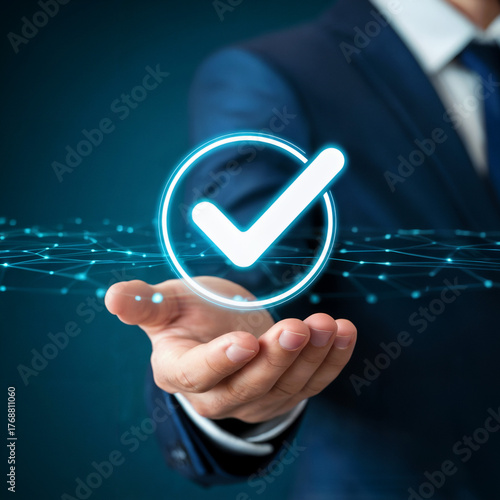 Businessman in suit holding glowing holographic checkmark over digital grid network symbolising success validation and approval