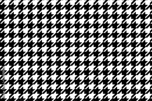 Pixeled black and white houndstooth pattern. Puppytooth background. Checkered motif. Plaid, scarf or cloth fabric print. Retro tweed design. Classic textile ornament. Vector graphic illustration.