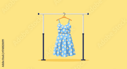 A light blue sundress with white daisies hangs on a wooden hanger from a white and black clothing rack
