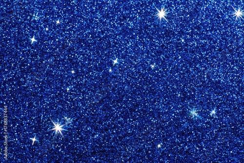 Royal Blue Glitter Texture Sparkling with Shimmering Light Reflects Across Surface Creating Festive and Glamorous Backdrop Ideal for Celebrations and Design Projects