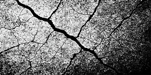 Arid dry cracked earth texture showing a pattern of cracks in the brown soil due to drought