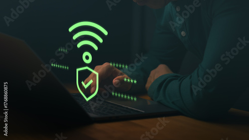 Man using a laptop computer with Wi-Fi security icon and checkmark, symbolizing safe internet connection, encrypted access, cybersecurity, and password protection for online data.