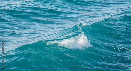 Fototapeta Naklejka Na Ścianę i Meble -  Close up of a small turquoise ocean wave with white foam crest