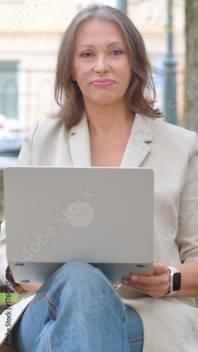 Old Senior Woman Shaking Head in Rejection while Using Laptop in Park