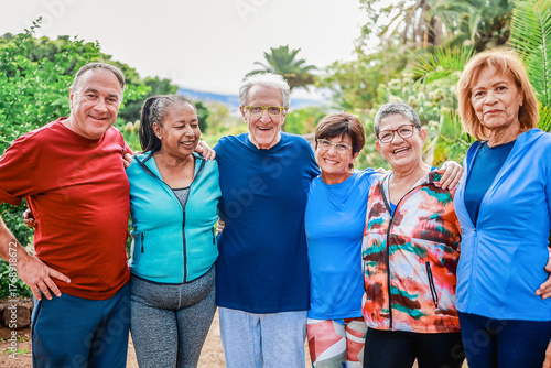 Group of diverse senior friends have fun after workout session at park - Active lifestyle, health and wellness concept