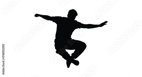 Dynamic silhouette of a male dancer in mid air with arms outstretched in a powerful leap