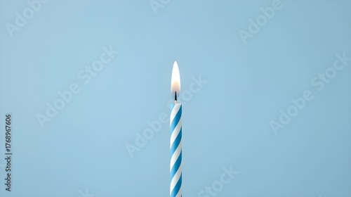 burning candle on blue background